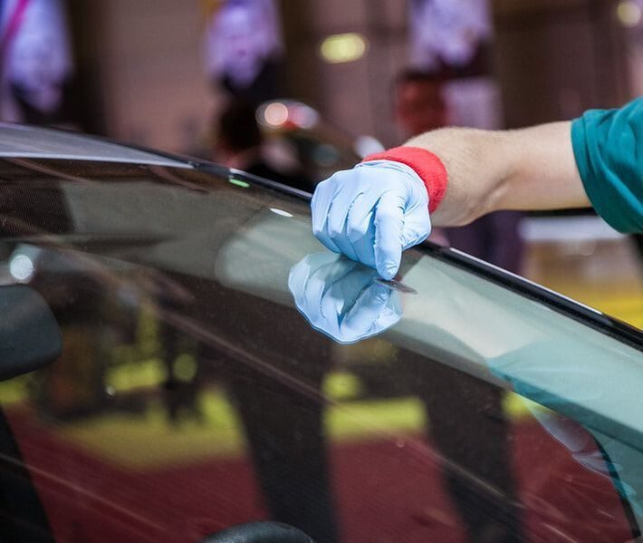 Auto glass technician repairing vehicle glass in Mobile, AL